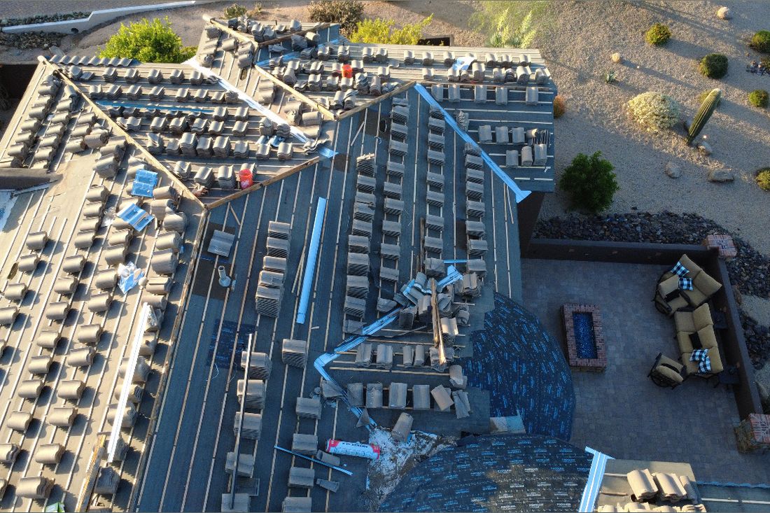 Aerial view of a tile roof lift-and-relay in progress on a Phoenix-area home